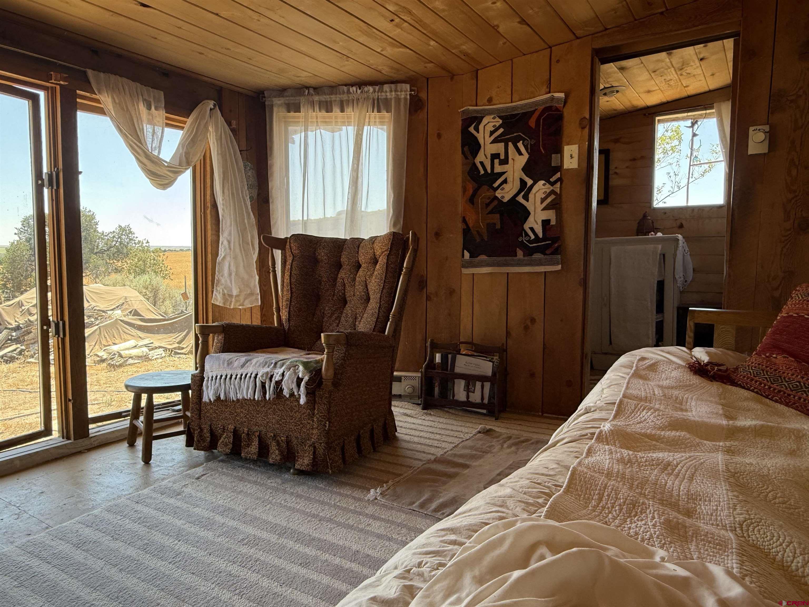 12730 Rd R Cahone, CO 81320 - Photo 11 of 34 a bed sitting in a bedroom next to a window