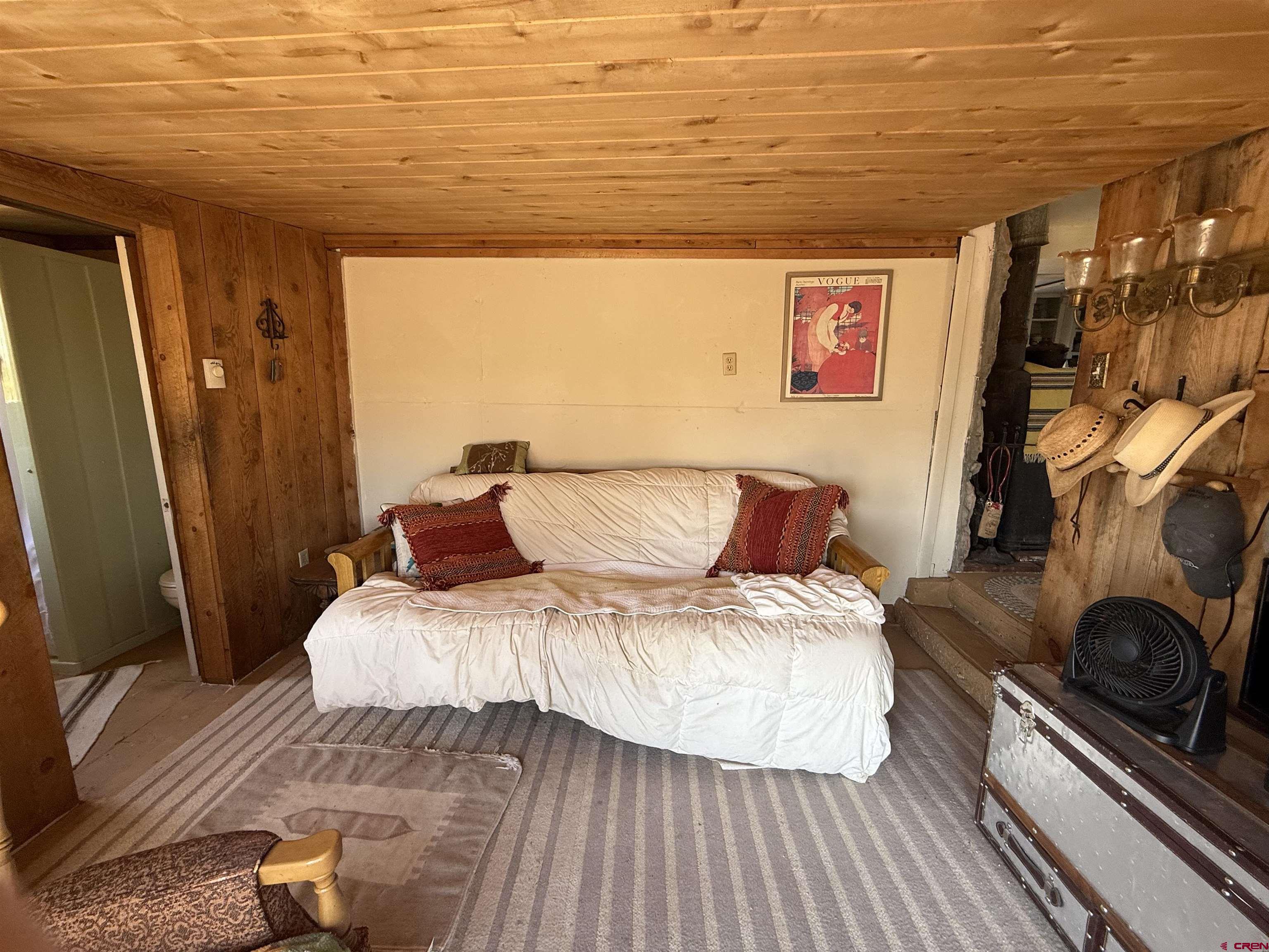 12730 Rd R Cahone, CO 81320 - Photo 12 of 34 a bedroom with a bed and wooden floor