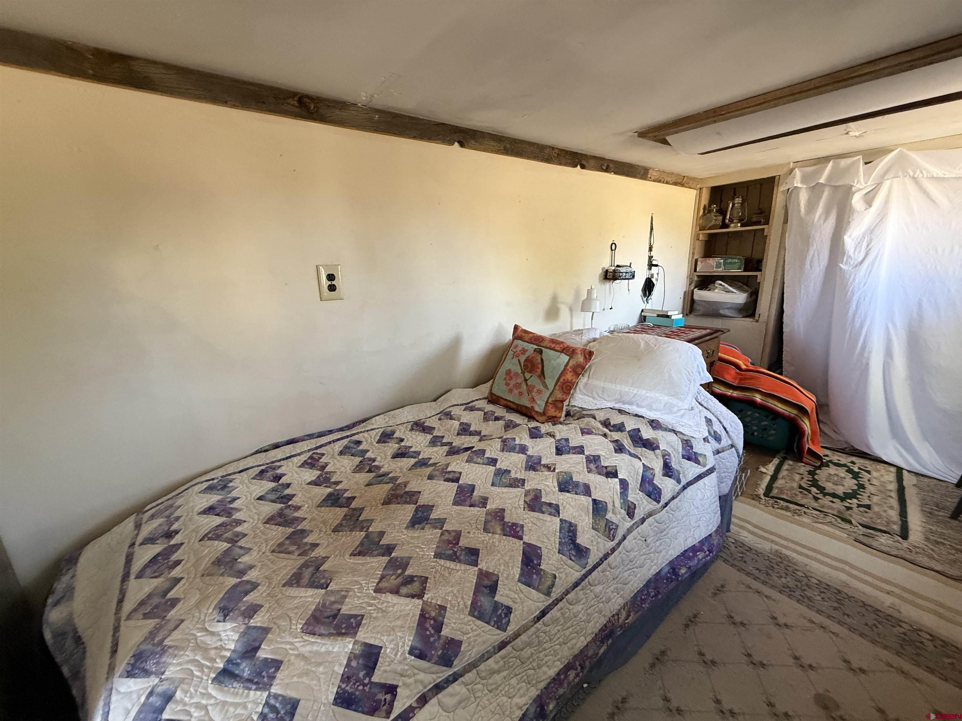 12730 Rd R Cahone, CO 81320 - Photo 16 of 34 a bedroom with a bed and wooden floor