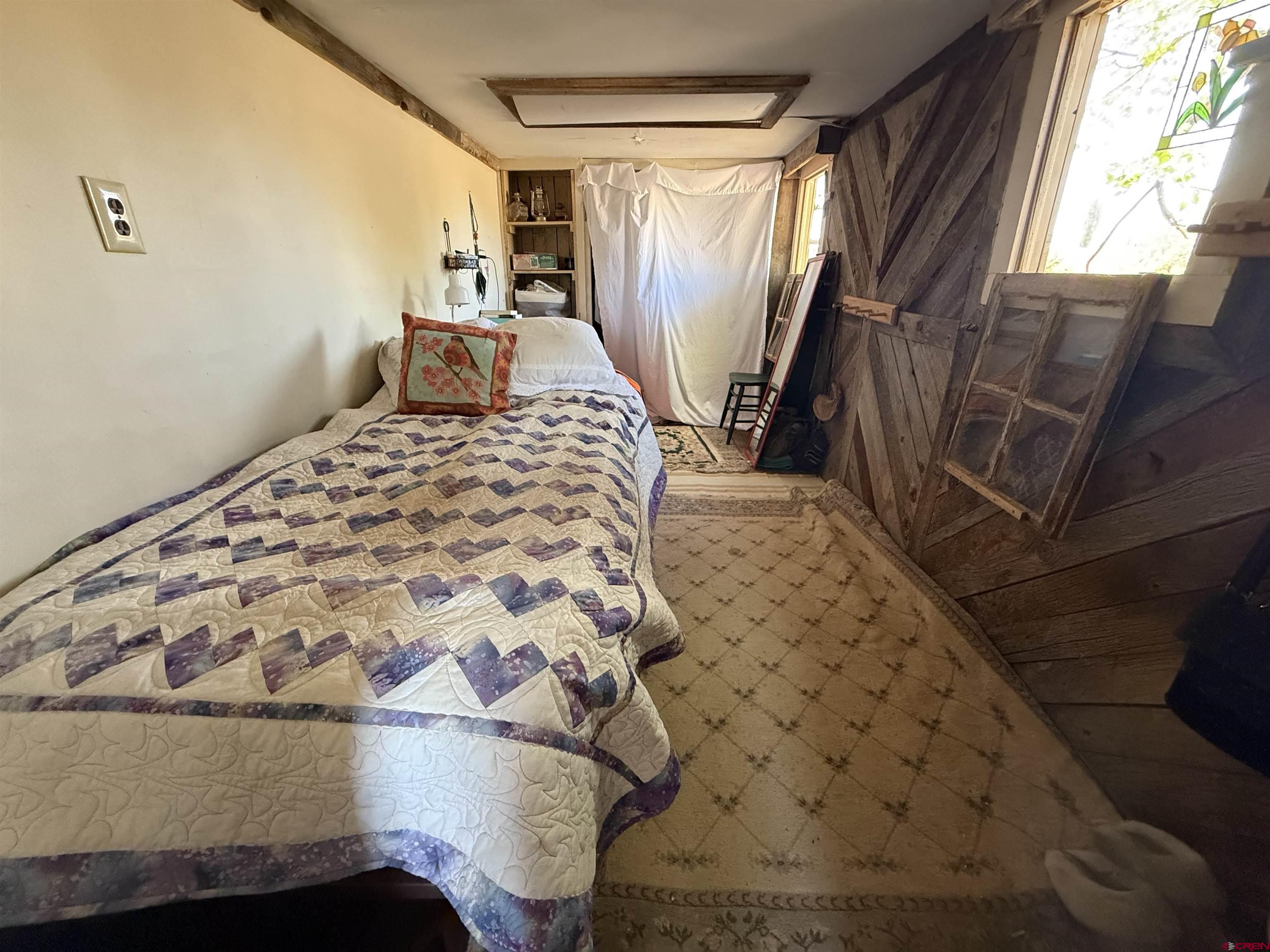 12730 Rd R Cahone, CO 81320 - Photo 17 of 34 a bedroom with a bed and a window