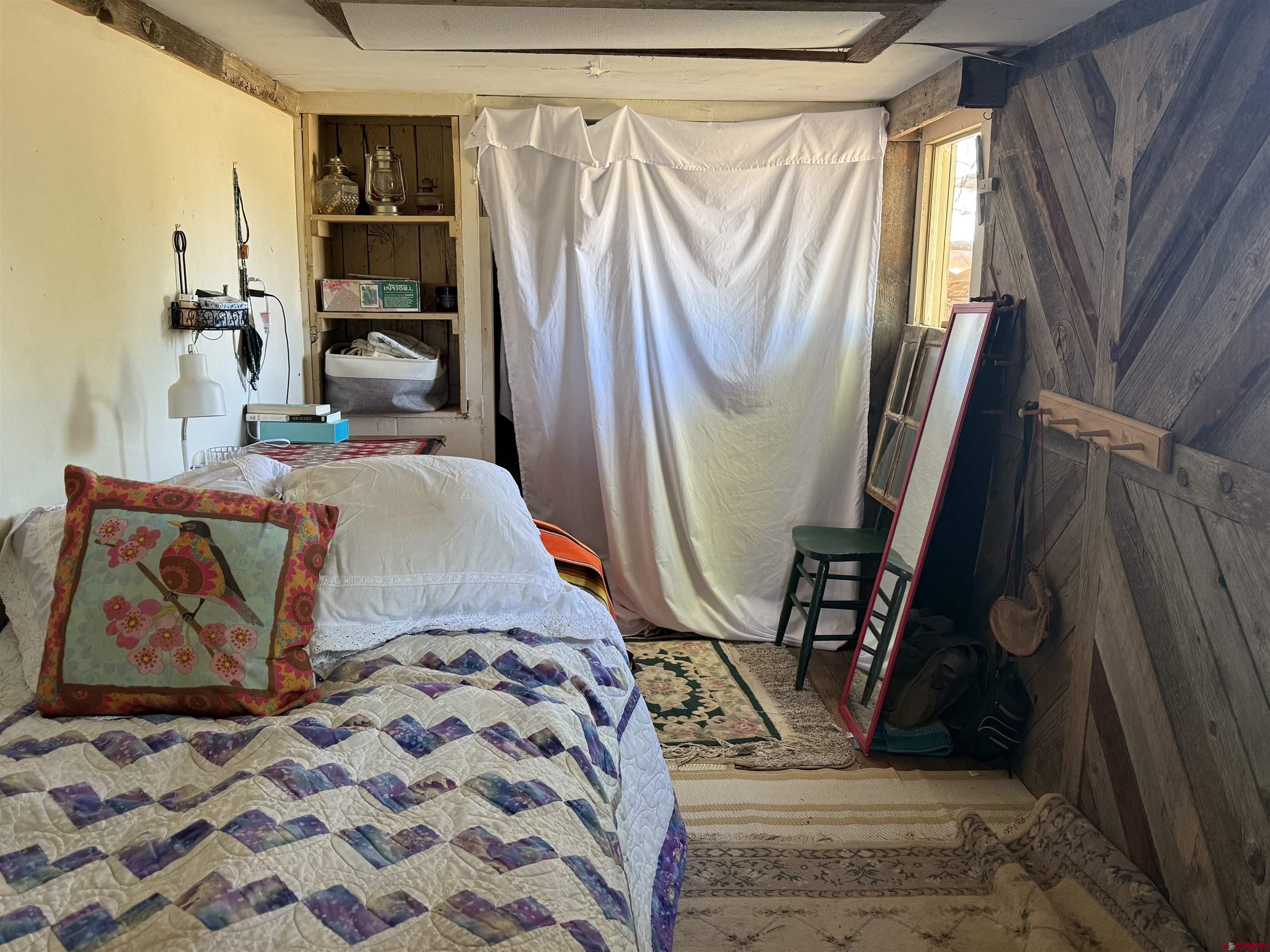 12730 Rd R Cahone, CO 81320 - Photo 18 of 34 a bed sitting in a bedroom next to a window