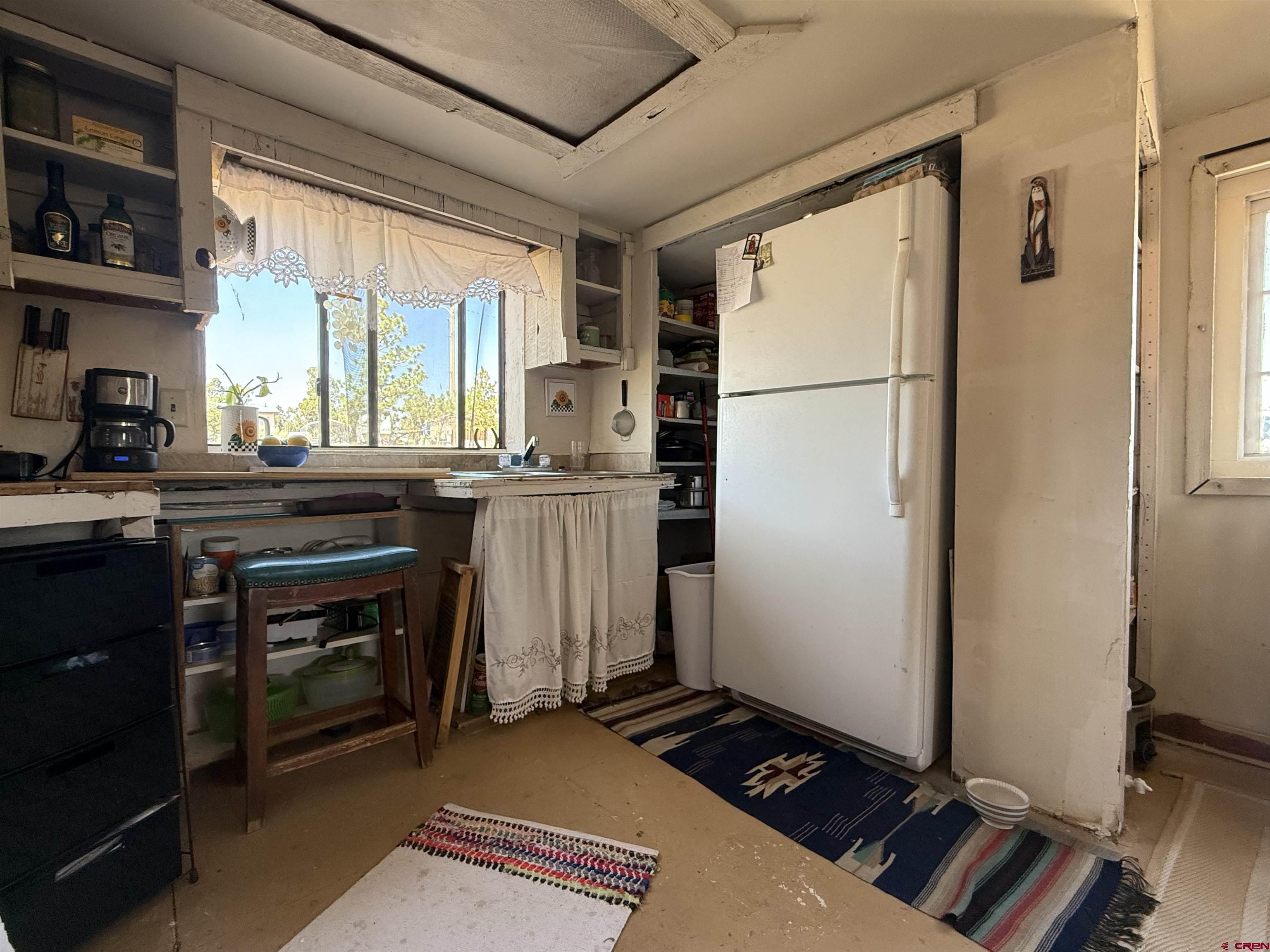 12730 Rd R Cahone, CO 81320 - Photo 4 of 34 a kitchen with a refrigerator and a stove