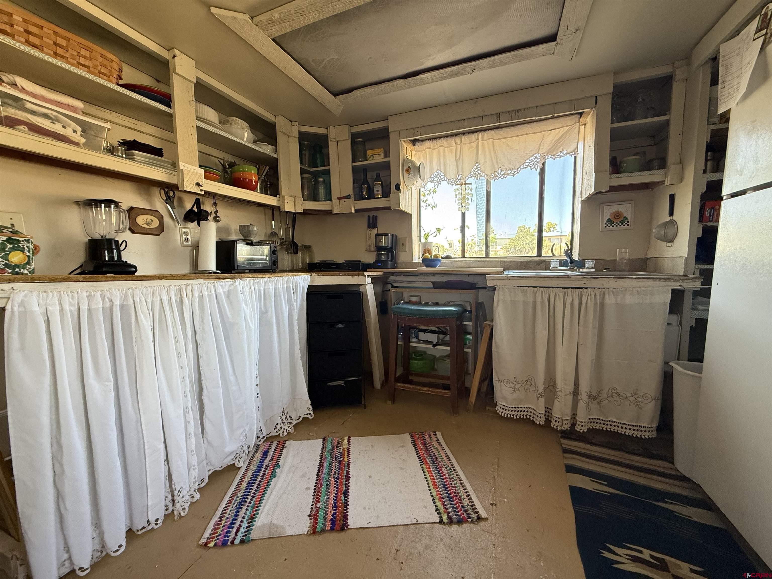 12730 Rd R Cahone, CO 81320 - Photo 5 of 34 a kitchen with stainless steel appliances granite countertop a stove a sink and a refrigerator