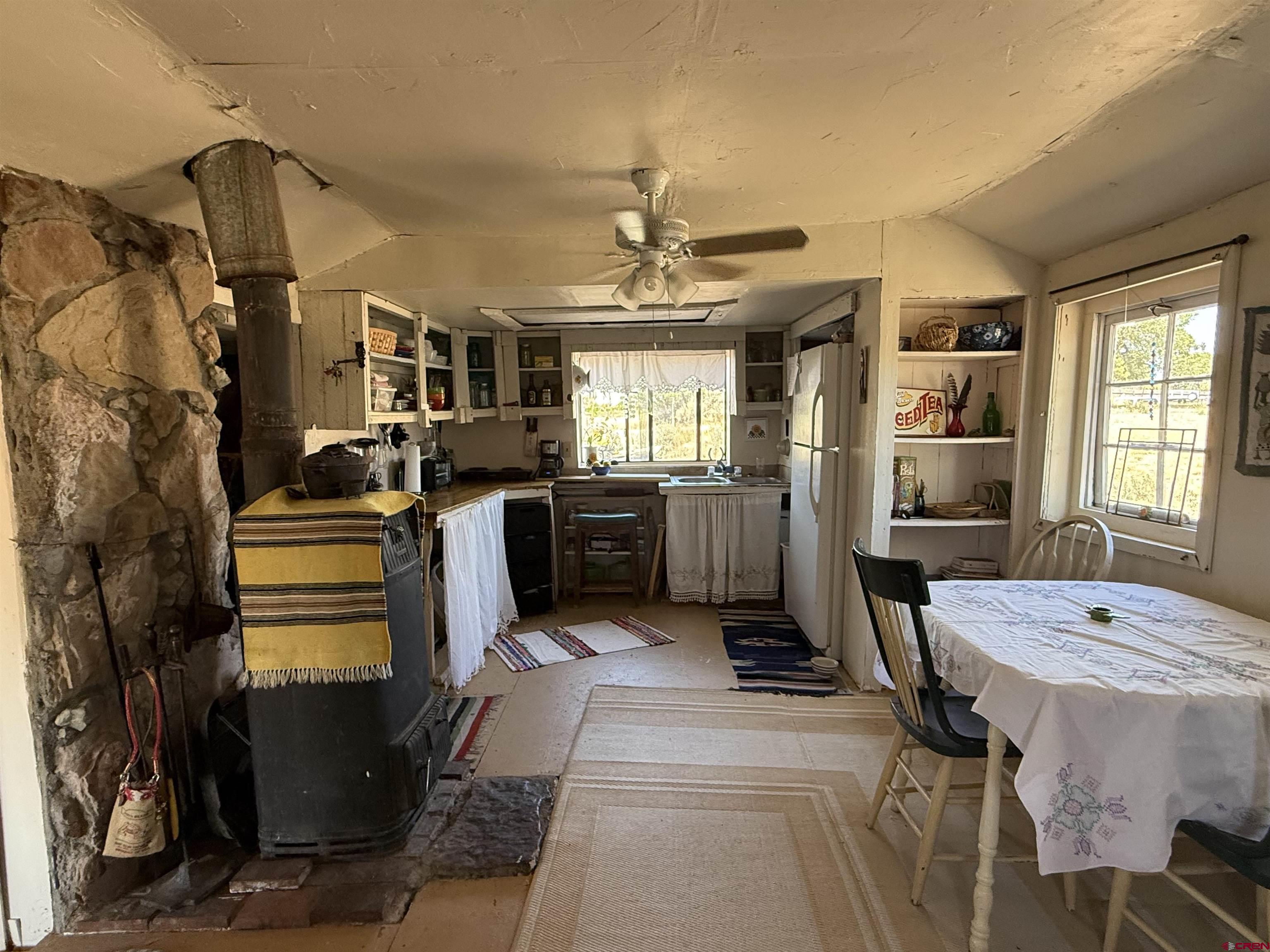 12730 Rd R Cahone, CO 81320 - Photo 8 of 34 a living room with furniture a window and kitchen view