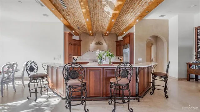 a kitchen with stainless steel appliances granite countertop a sink and a refrigerator