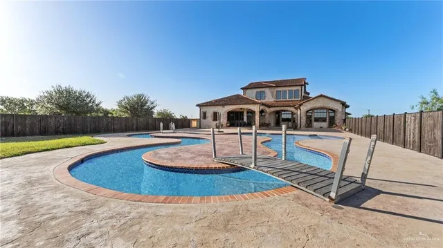 a swimming pool with outdoor seating and yard