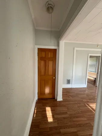 a view of a hallway with wooden floor