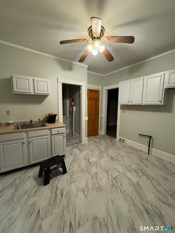a kitchen with kitchen island cabinets and appliances
