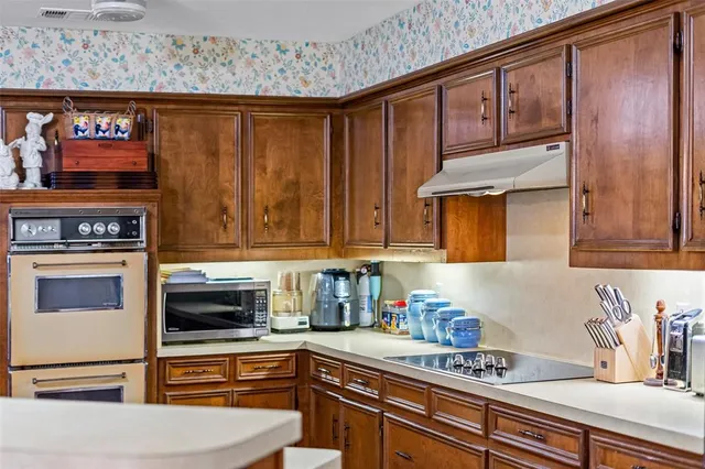 a kitchen with stainless steel appliances granite countertop a refrigerator and stove