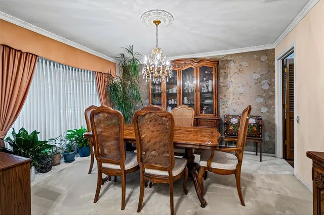 a view of a dining room with furniture and chandelier