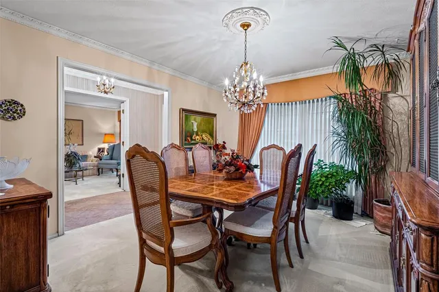 a view of a dining room with furniture and a chandelier