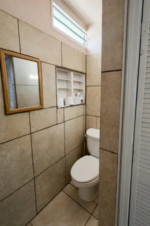 a bathroom with a toilet and a shower