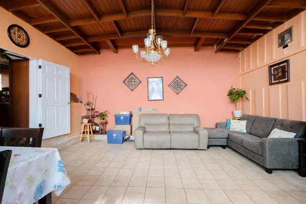a living room with furniture and a chandelier