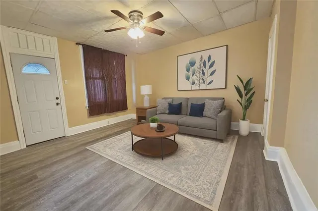 a living room with furniture and a chandelier