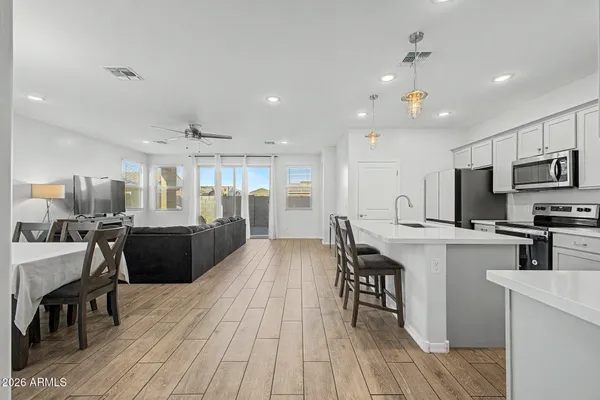 a large kitchen with stainless steel appliances lots of counter space and breakfast area