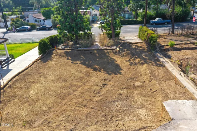 a view of a backyard with swimming pool