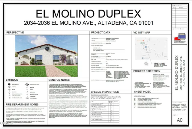 a view of a white house with a yard plants and large tree