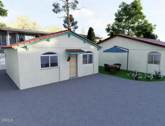 a house view with a seating space and garden