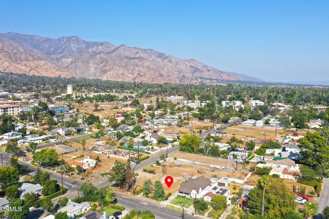 an aerial view of residential house and sandy dunes
