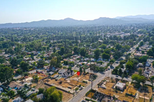 an aerial view of a city and mountains