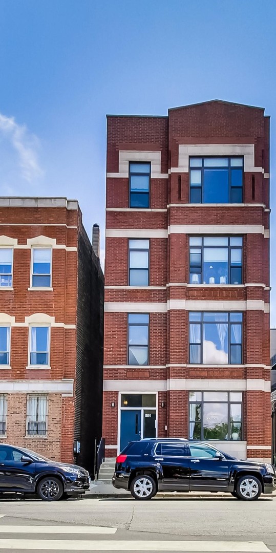 613 North Racine Avenue, Unit 1 Chicago, IL 60642 - Photo 1 of 21 a red brick building that has lot of windows on it