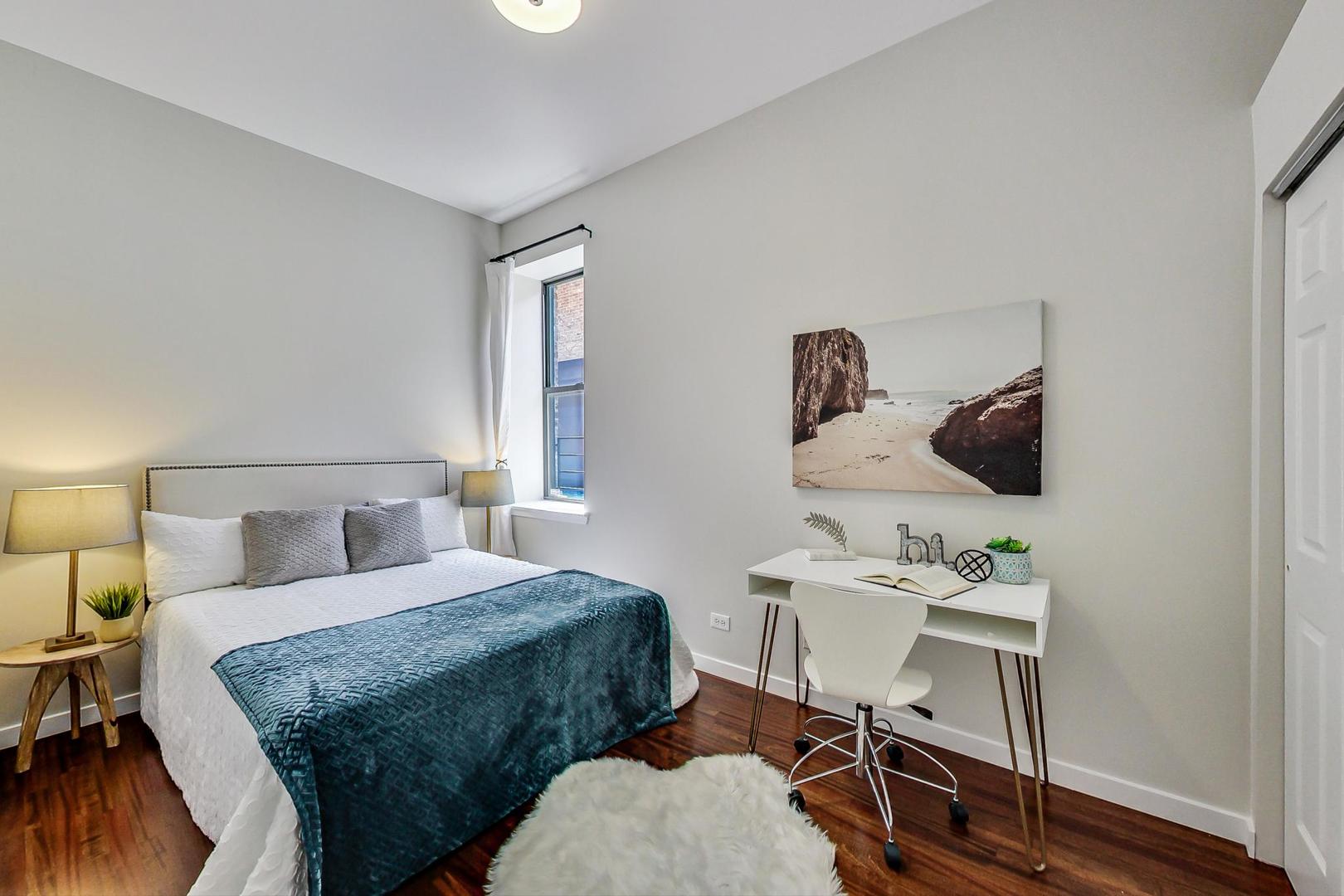 613 North Racine Avenue, Unit 1 Chicago, IL 60642 - Photo 11 of 21 a bedroom with a bed and wooden floor