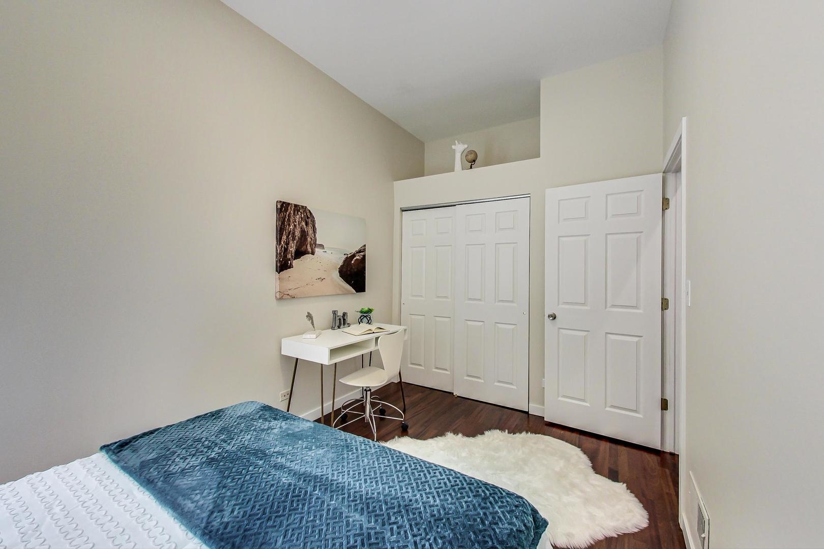 613 North Racine Avenue, Unit 1 Chicago, IL 60642 - Photo 12 of 21 a bedroom with a bed and a table
