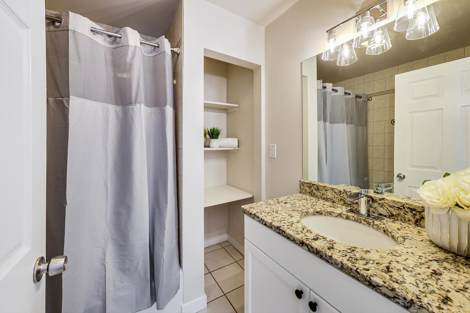 613 North Racine Avenue, Unit 1 Chicago, IL 60642 - Photo 13 of 21 a bathroom with a granite countertop sink and a mirror