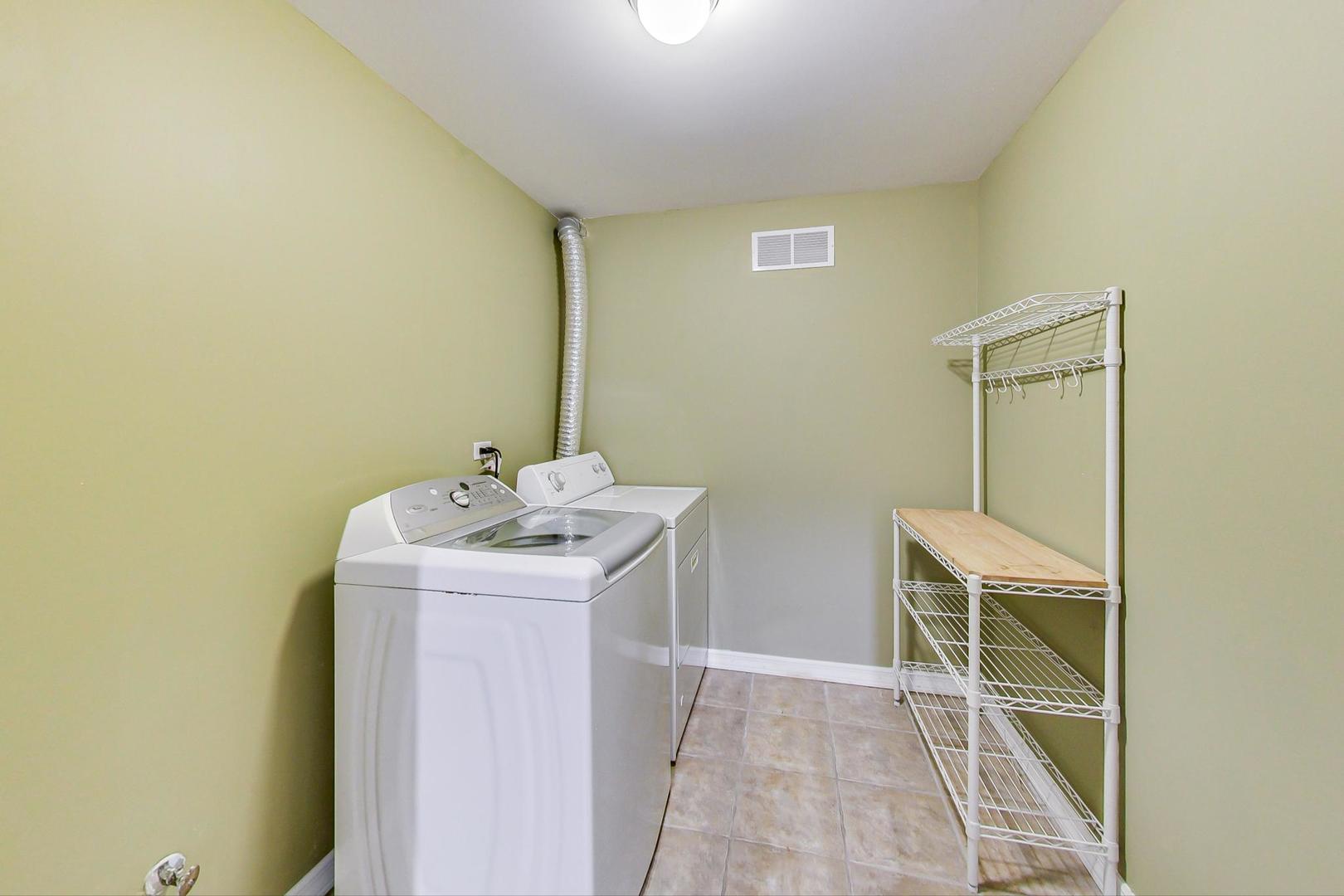 613 North Racine Avenue, Unit 1 Chicago, IL 60642 - Photo 18 of 21 a utility room with a sink dryer and washer
