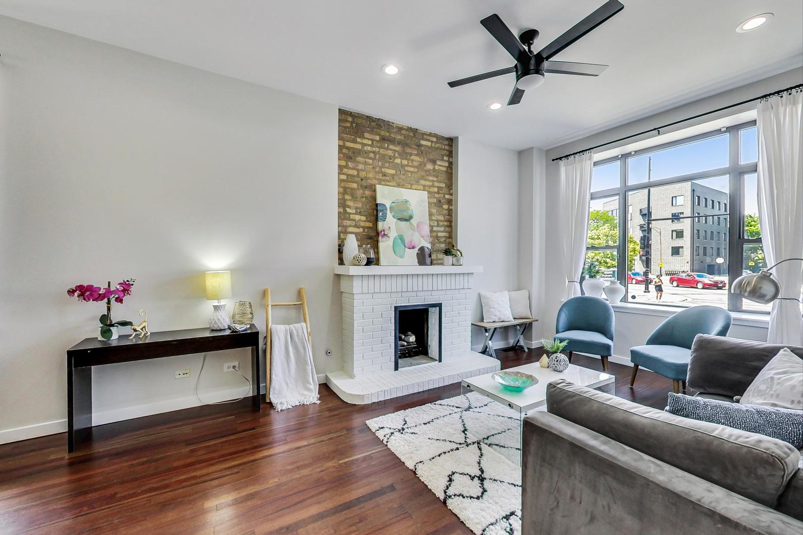 613 North Racine Avenue, Unit 1 Chicago, IL 60642 - Photo 2 of 21 a living room with furniture and a fireplace