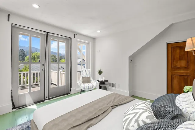 a bedroom with a large bed and a large window