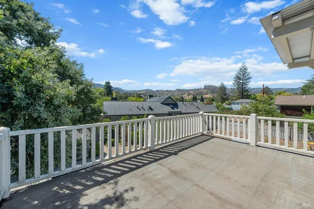 a view of a balcony with wooden fence and floor