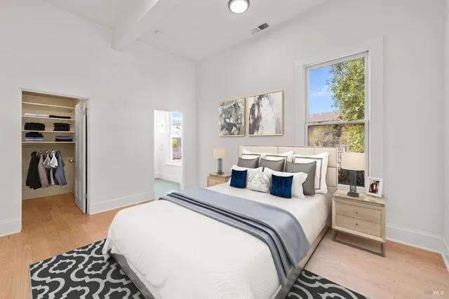 a bedroom with a bed and a window