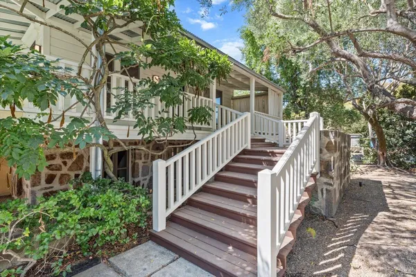 a view of a house with backyard and deck