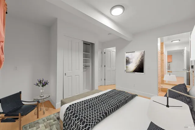 a bedroom with a bed and a chair