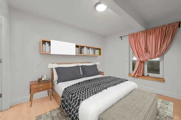 a bedroom with a bed and a chair