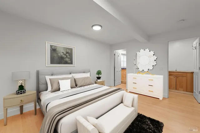 a spacious bedroom with a bed and a chandelier