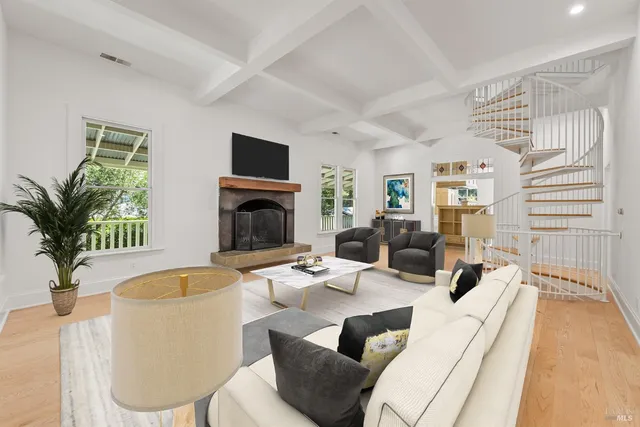 a living room with furniture fireplace and a flat screen tv