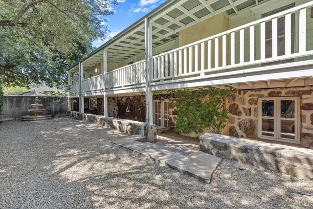 a view of a house with backyard porch and sitting area