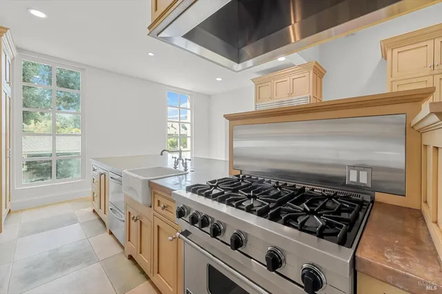 a kitchen with stove and cabinets