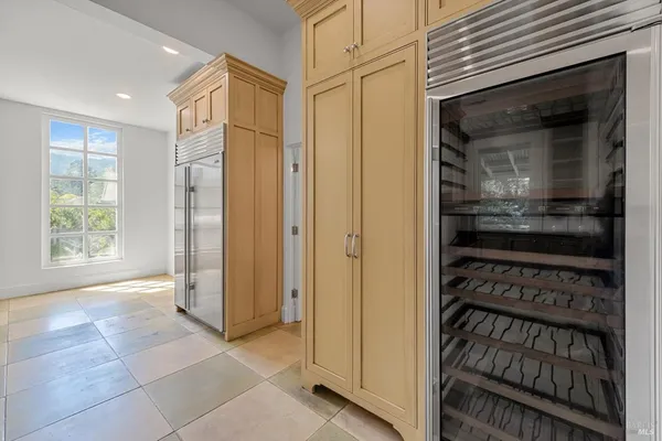 a view of a hallway with wooden shelves