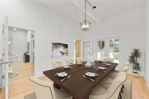 a living room with dining table and a table