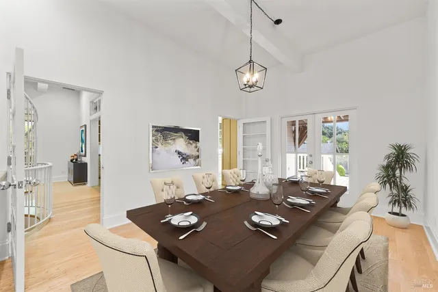 a living room with dining table and a table