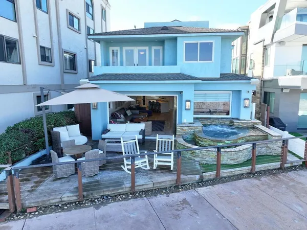 a view of a house with backyard porch and sitting area