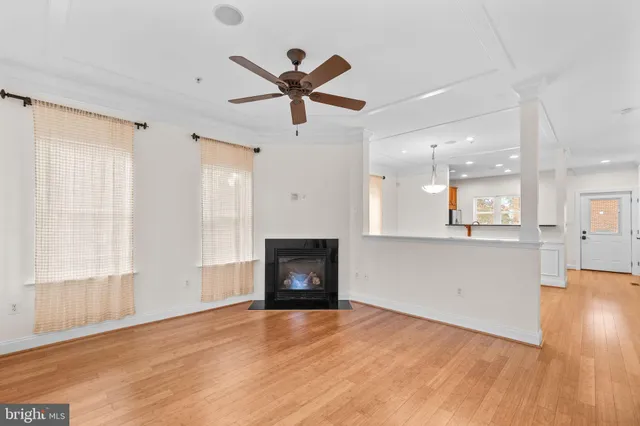 a view of empty room with wooden floor and window