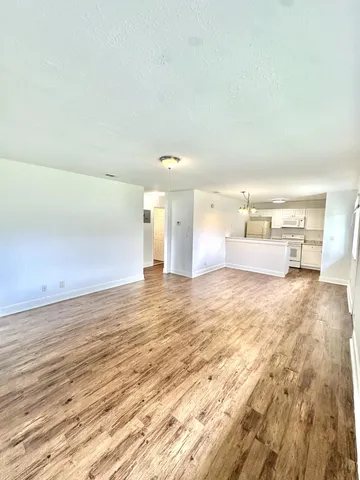 a view of kitchen and empty room