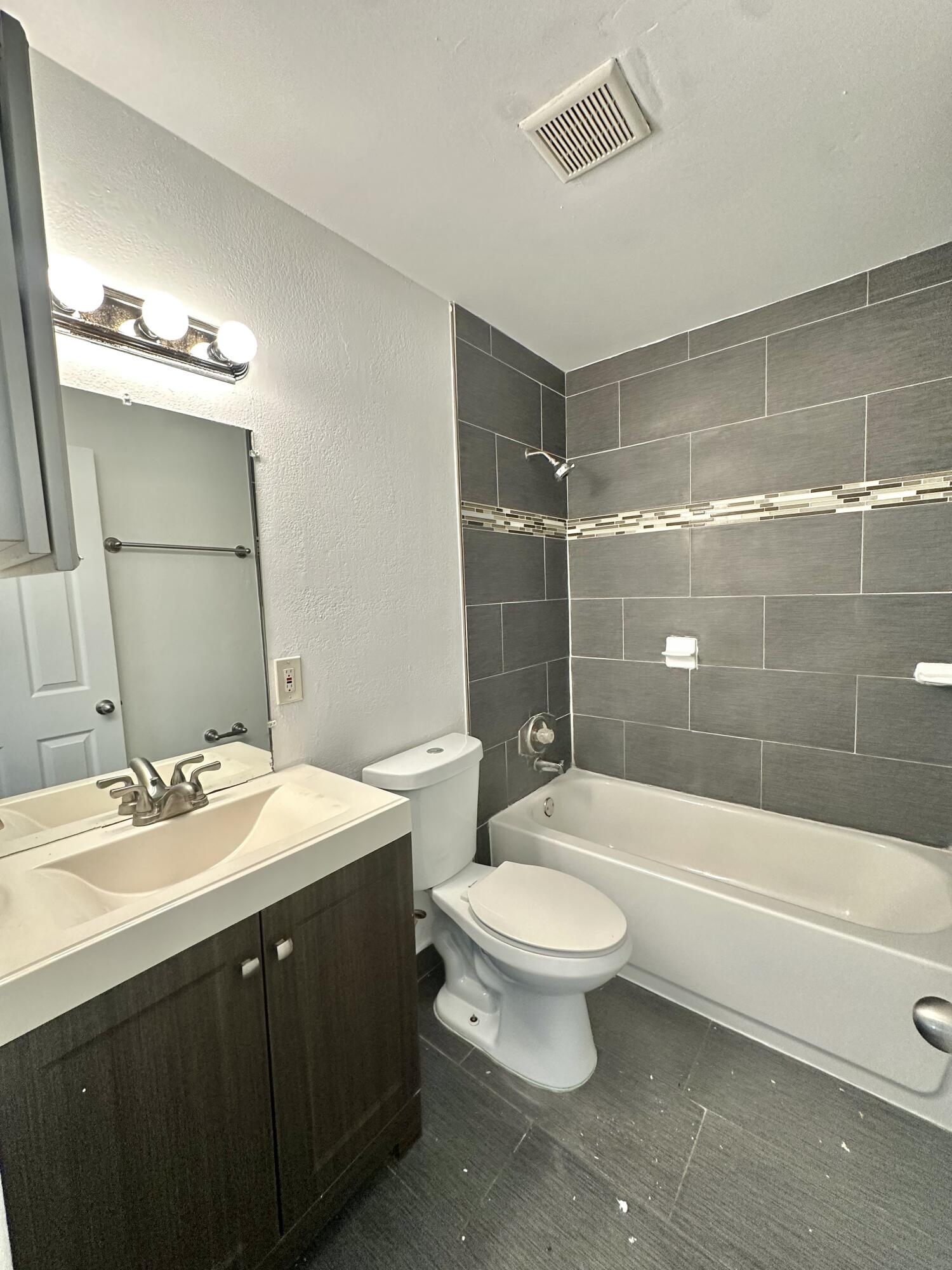 210 Tiffany Drive East, Unit 1 West Palm Beach, FL 33407 - Photo 4 of 10 a bathroom with a sink a toilet and shower