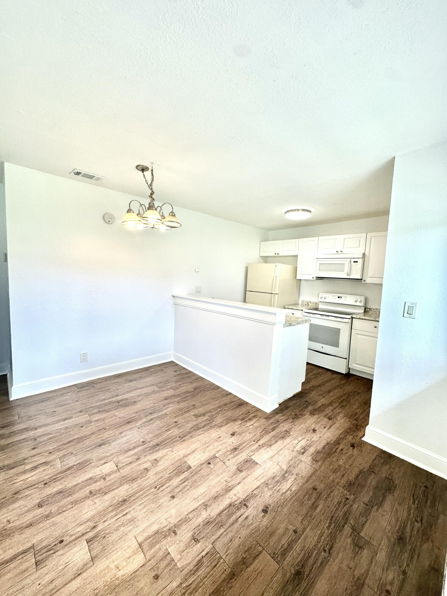 210 Tiffany Drive East, Unit 1 West Palm Beach, FL 33407 - Photo 9 of 10 a view of a kitchen with wooden floor