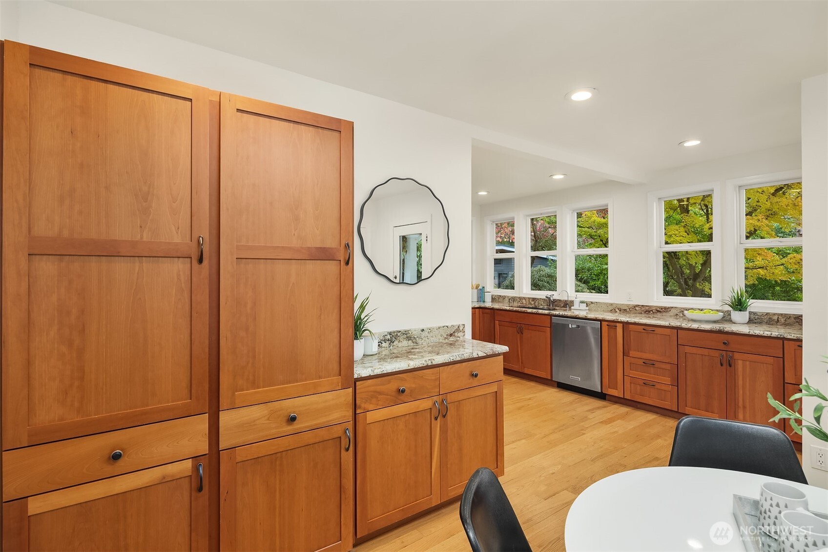 5722 Keystone Place North Seattle, WA 98103 - Photo 11 of 38 a large kitchen with kitchen island a large window and a sink