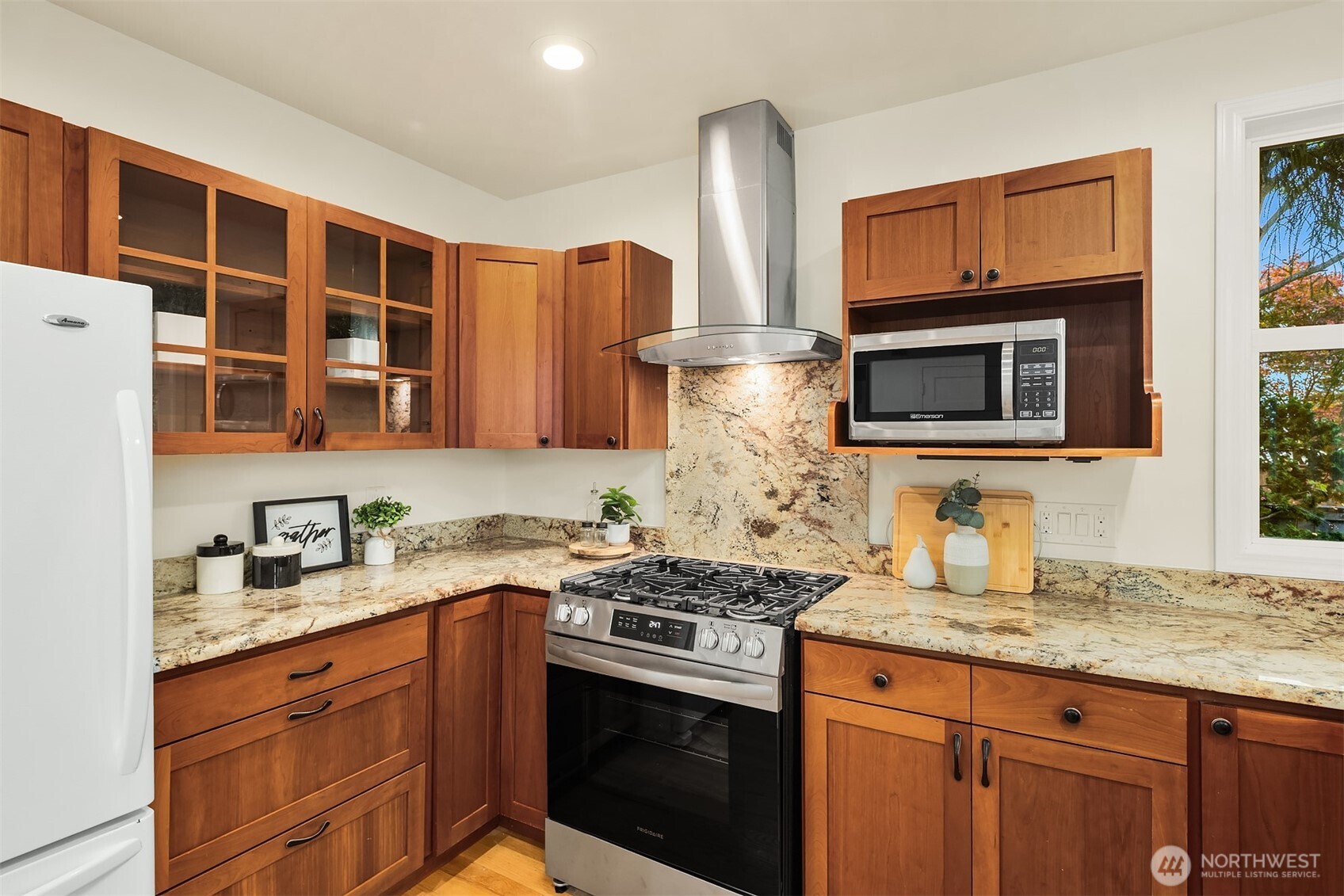 5722 Keystone Place North Seattle, WA 98103 - Photo 14 of 38 a kitchen with stainless steel appliances granite countertop a stove microwave and refrigerator